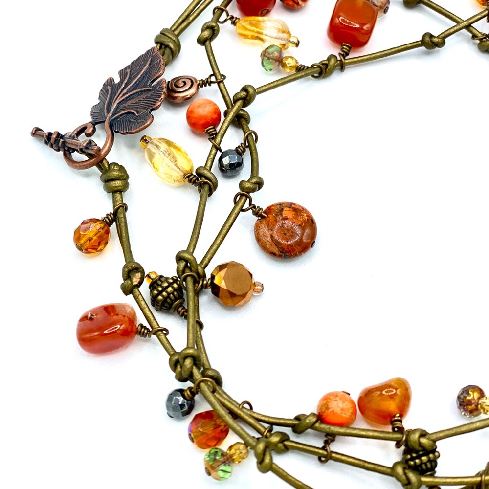 Dyed leather cord, glass, metal, shell, ceramic and stone beads.